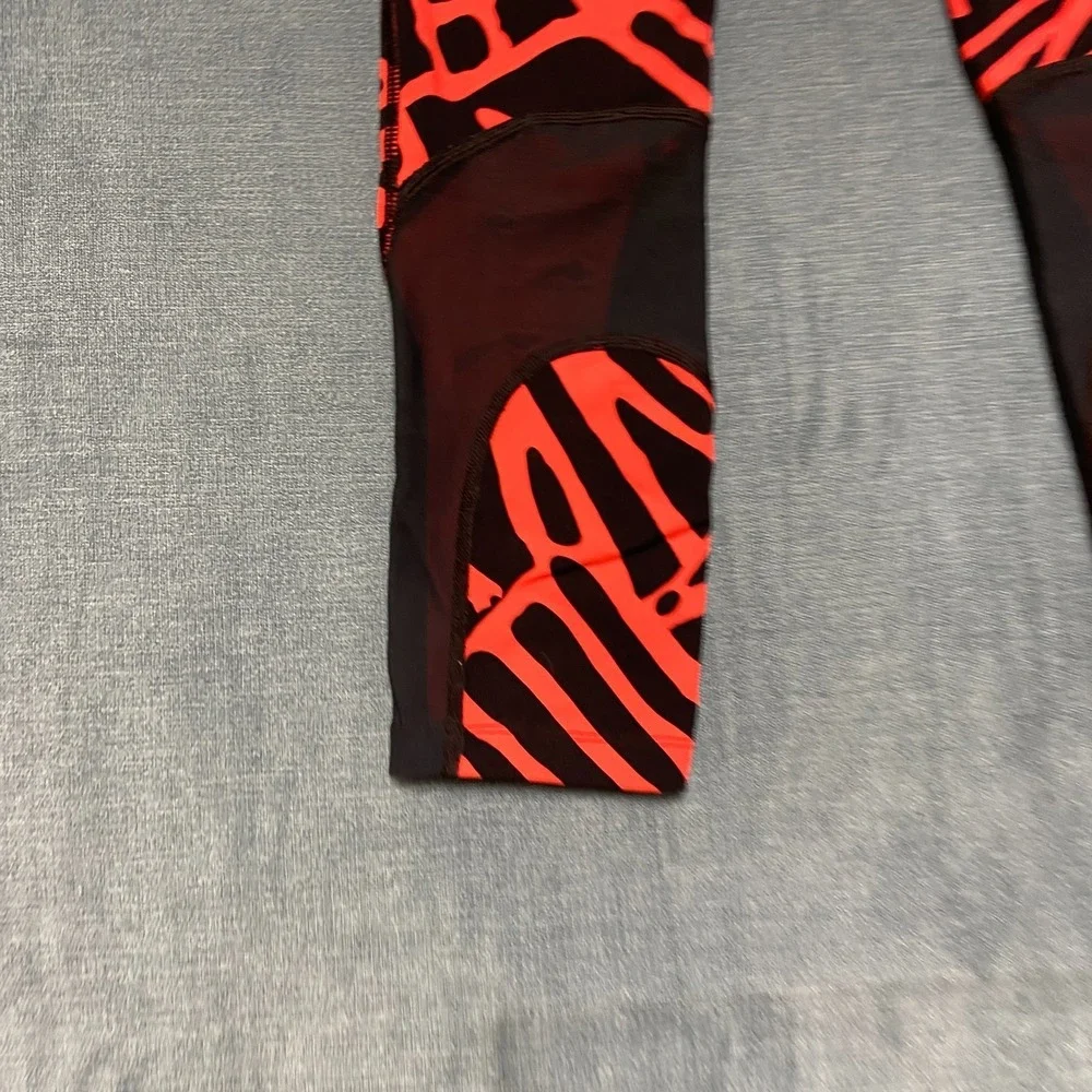 Nike Dri Fit Power Epic Lux Capri Leggings Womens XS Black Orange Abstract Print